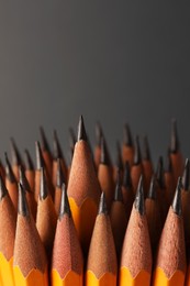 Photo of Many sharp graphite pencils on grey background, space for text