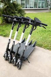 Photo of Row of electric scooters outdoors. Rental service