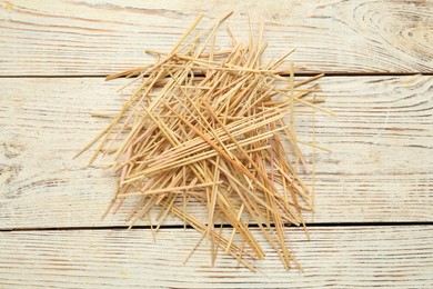 Photo of Heap of dried hay on white wooden background, flat lay