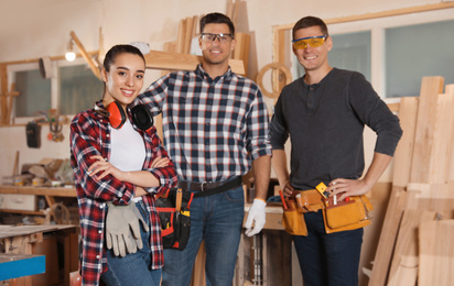 Photo of Team of professional carpenters in modern workshop