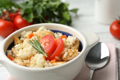 Photo of Delicious chicken risotto served in bowl, closeup