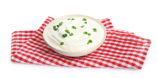 Fresh sour cream with onion and fabric on white background