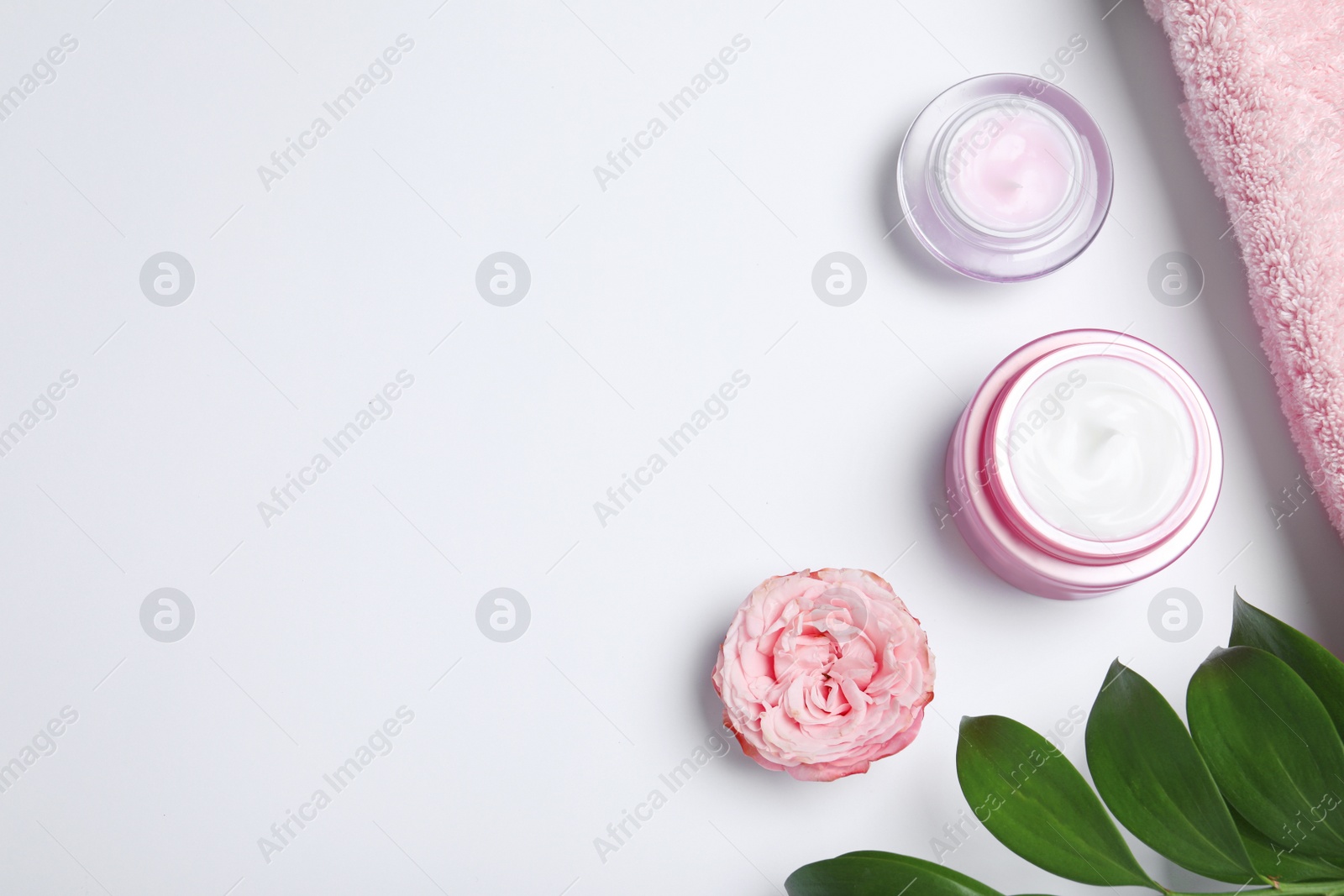 Photo of Flat lay composition with jars of cream on white background. Space for text
