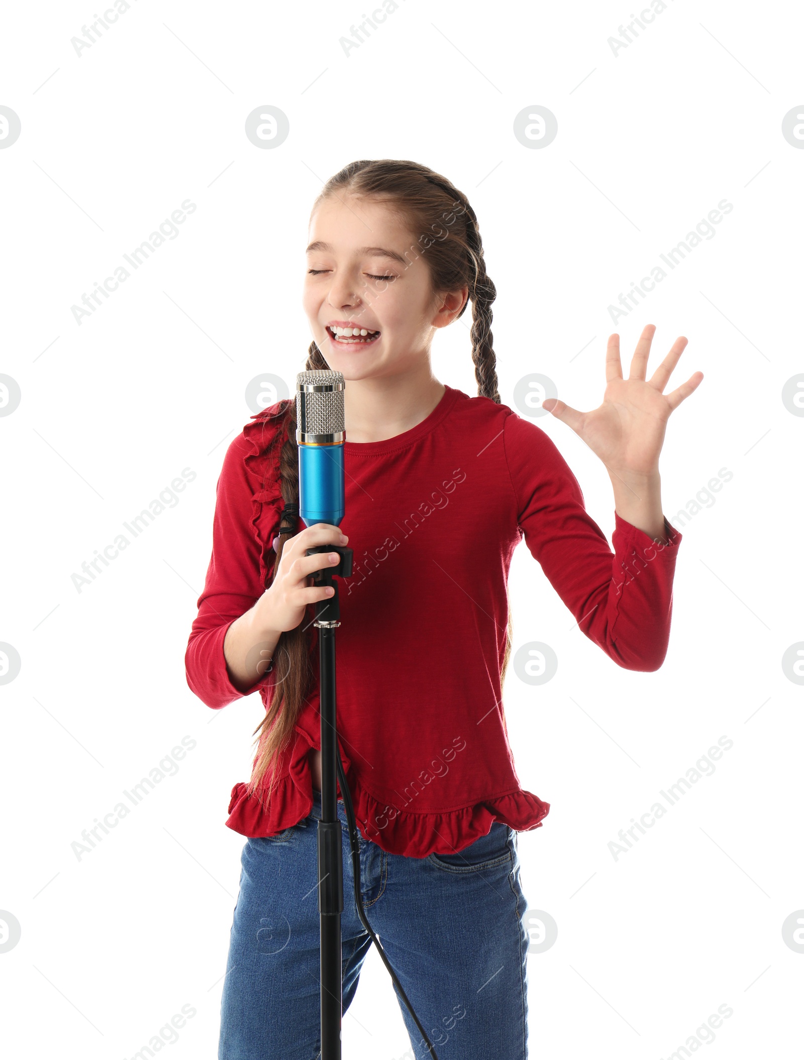 Photo of Cute girl singing in microphone on white background