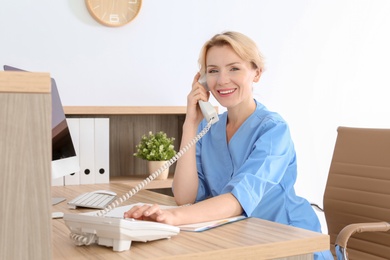 Photo of Female medical assistant at workplace in clinic. Health care service