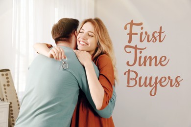 Image of First-time buyer. Happy young couple with key hugging in their new house