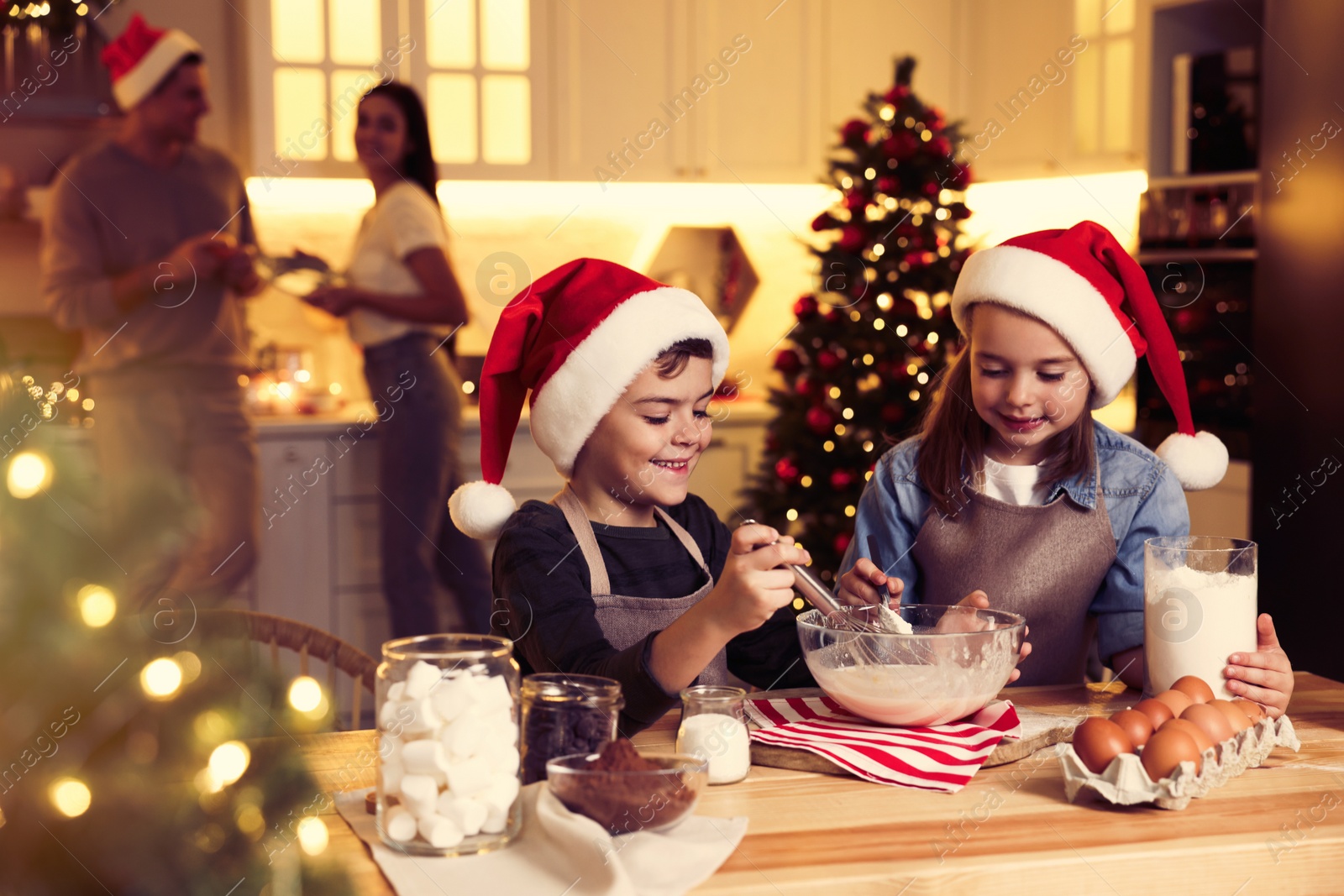 Photo of Cute little children making dough for delicious Christmas cookies at home