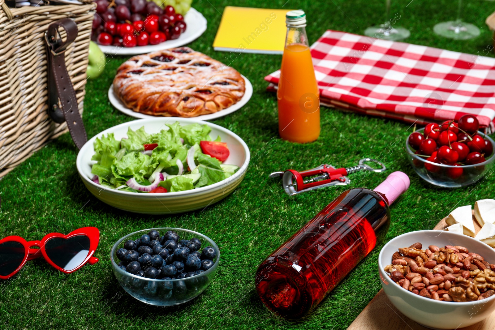 Photo of Many different products on green grass. Summer picnic