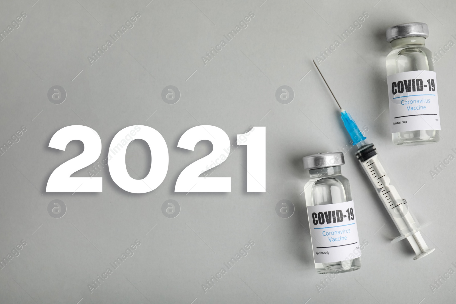 Image of Vials with coronavirus vaccine and syringe on light background, flat lay 