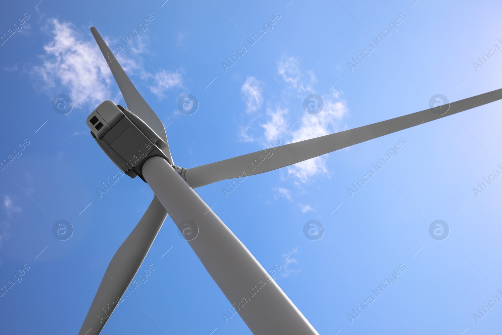 Photo of Wind turbine against beautiful blue sky, low angle view. Alternative energy source