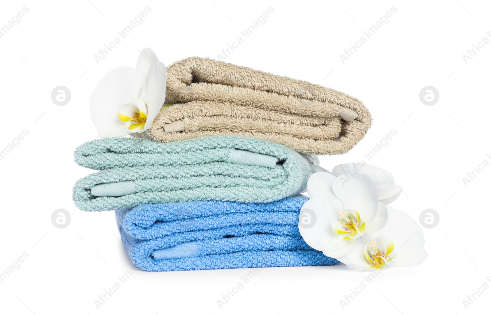 Photo of Stack of clean soft towels with orchids isolated on white