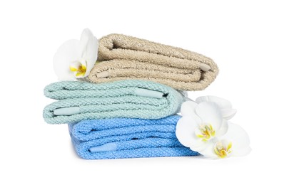 Stack of clean soft towels with orchids isolated on white