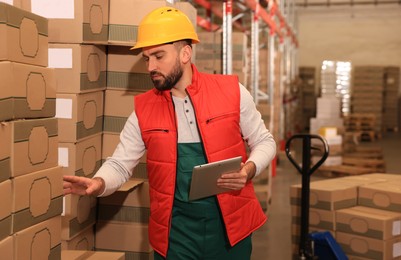 Man with tablet working at warehouse. Logistics center