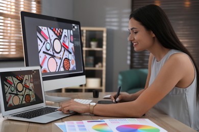 Professional retoucher working on computer in office