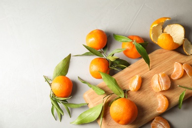 Flat lay composition with ripe tangerines on grey background. Space for text