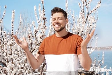 Photo of Happy healthy man enjoying springtime outdoors. Allergy free concept