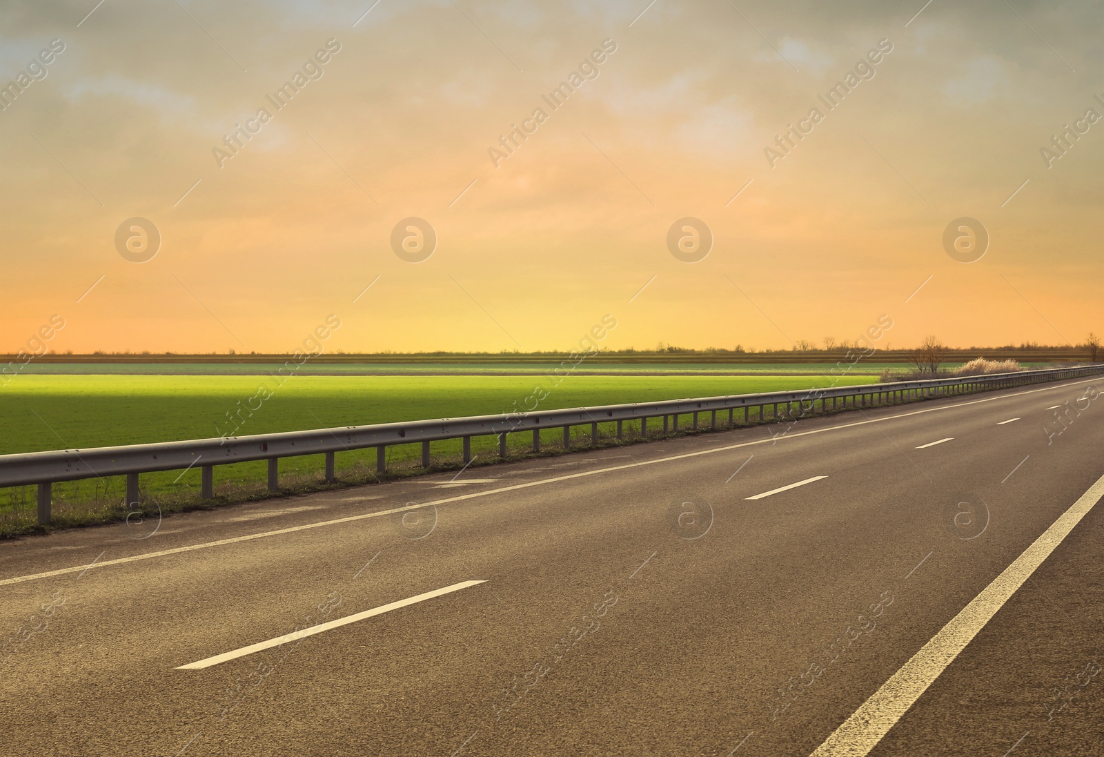 Image of Road trip. Beautiful view of asphalt highway at sunset 