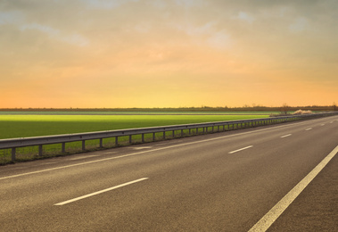 Image of Road trip. Beautiful view of asphalt highway at sunset 