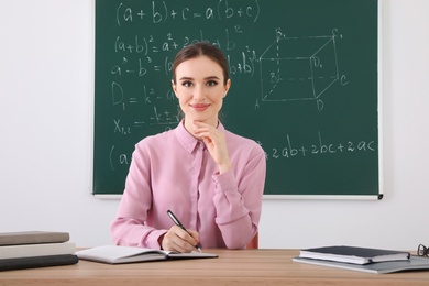 Portrait of young female teacher in classroom