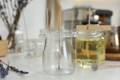 Photo of Empty glass jar on white table. Handmade candle