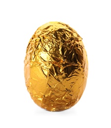 Photo of Chocolate egg wrapped in bright golden foil isolated on white