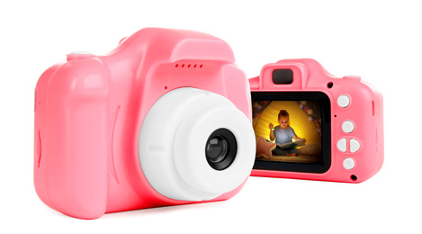 Image of Pink toy cameras on white background in collage, one with photo of cute little girl reading book at home 