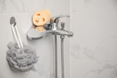 Grey shower puff and loofah sponge in bathroom, space for text