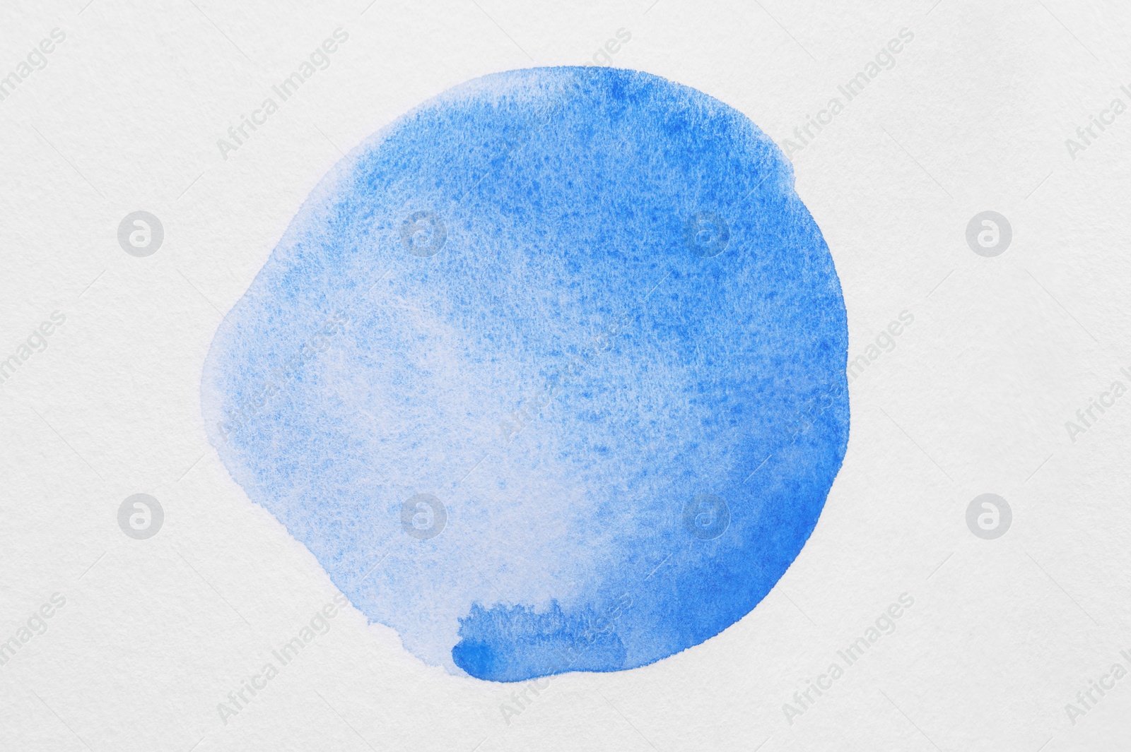 Photo of Blot of blue watercolor paint on white background, top view