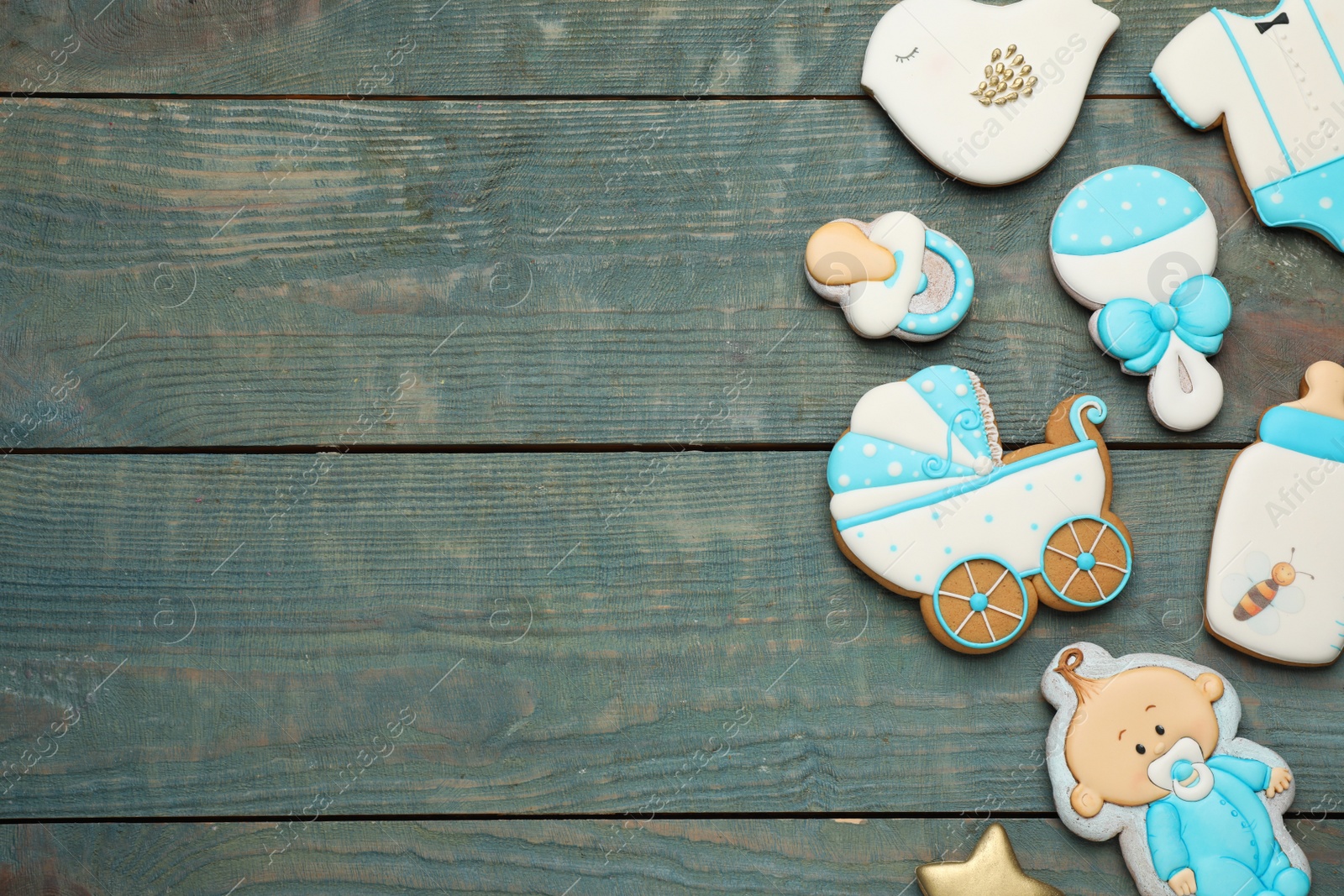 Photo of Set of baby shower cookies on light blue wooden table, flat lay. Space for text