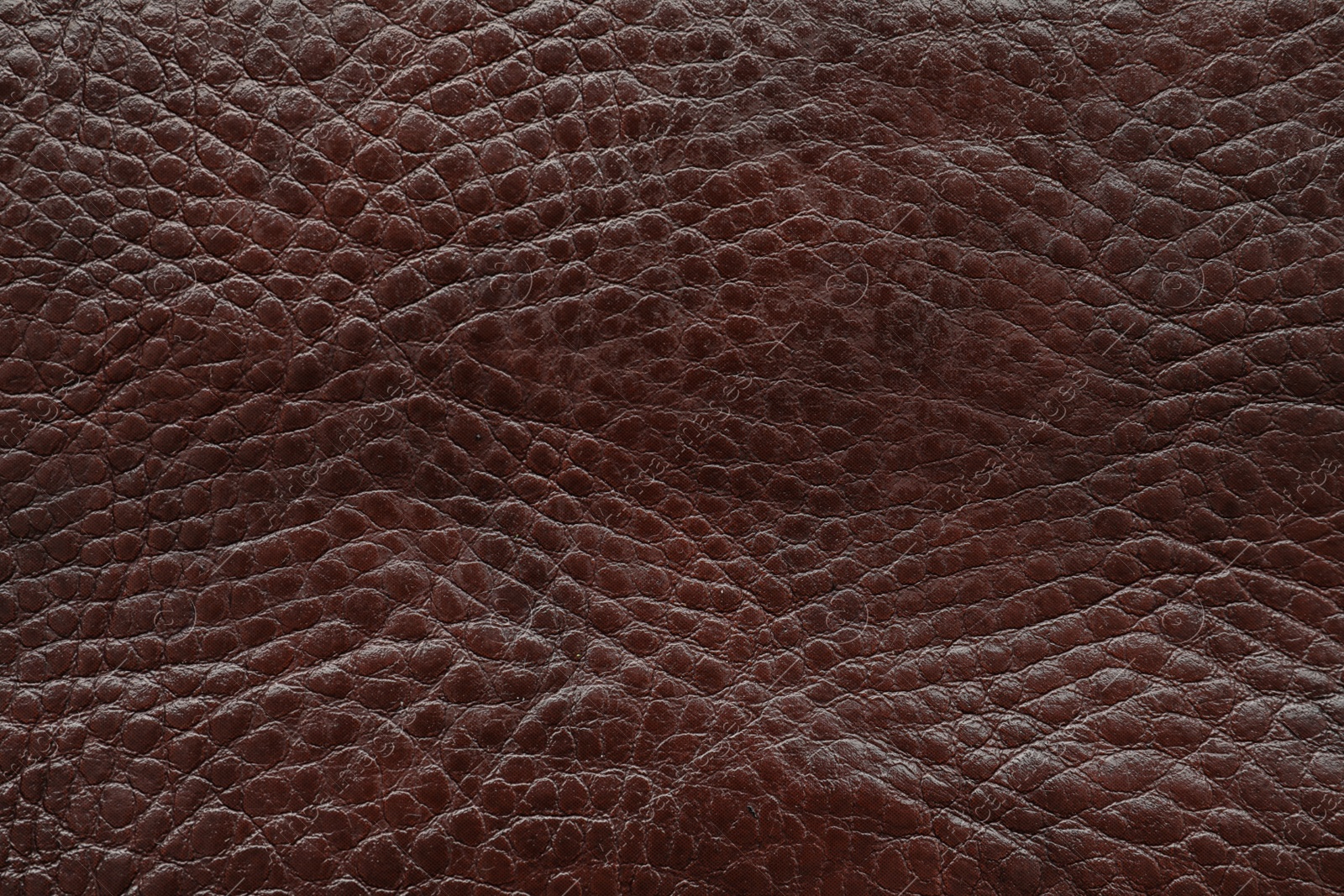 Photo of Texture of dark brown leather as background, closeup