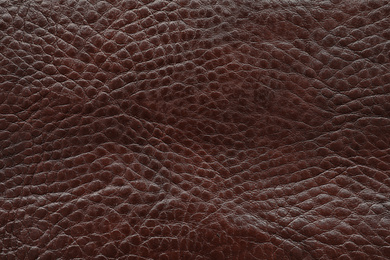 Photo of Texture of dark brown leather as background, closeup