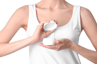 Young woman with jar of hand cream on white background, closeup