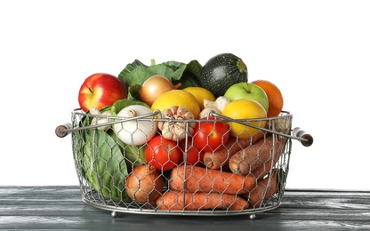 Photo of Variety of fresh delicious vegetables and fruits in basket on table against white background