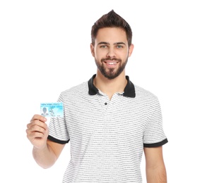 Happy young man with driving license on white background