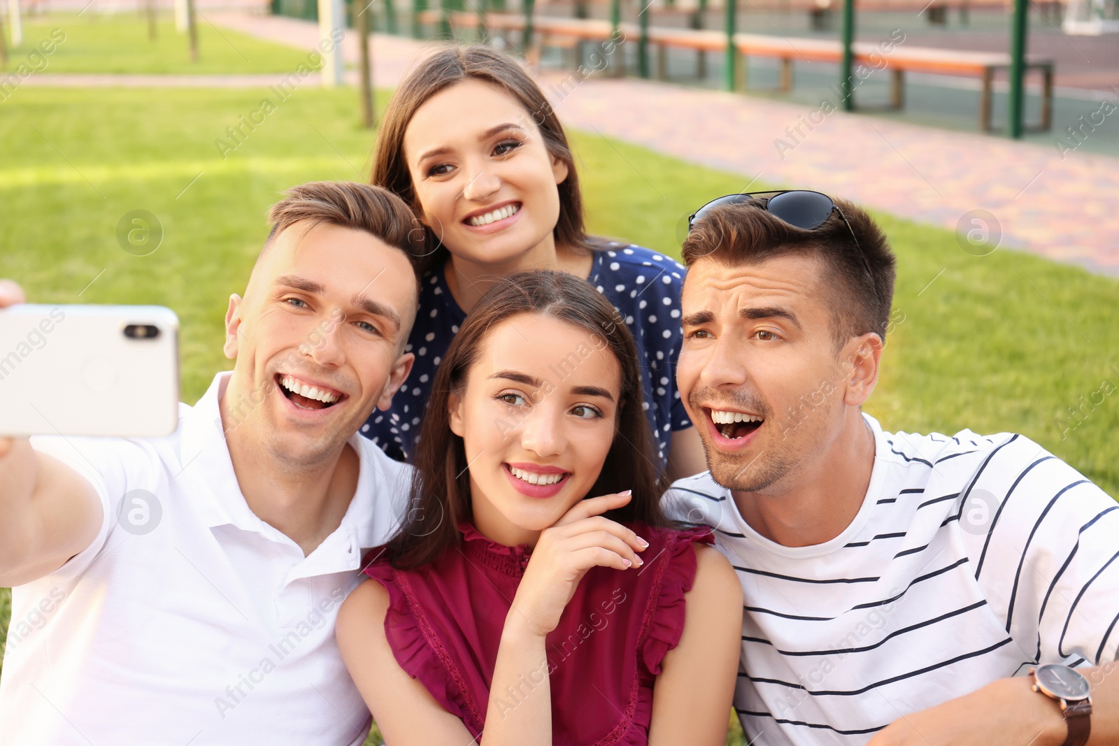 Photo of Group of young people taking selfie outdoors