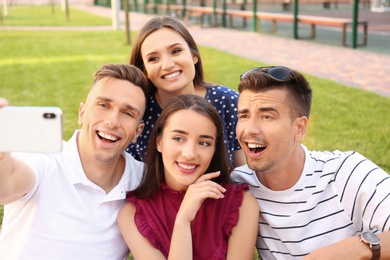 Group of young people taking selfie outdoors