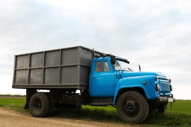 Photo of Truck with seedlings in field on spring day. Agricultural industry
