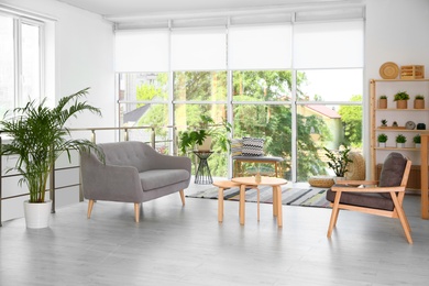 Photo of Modern living room interior with comfortable couch and wooden furniture