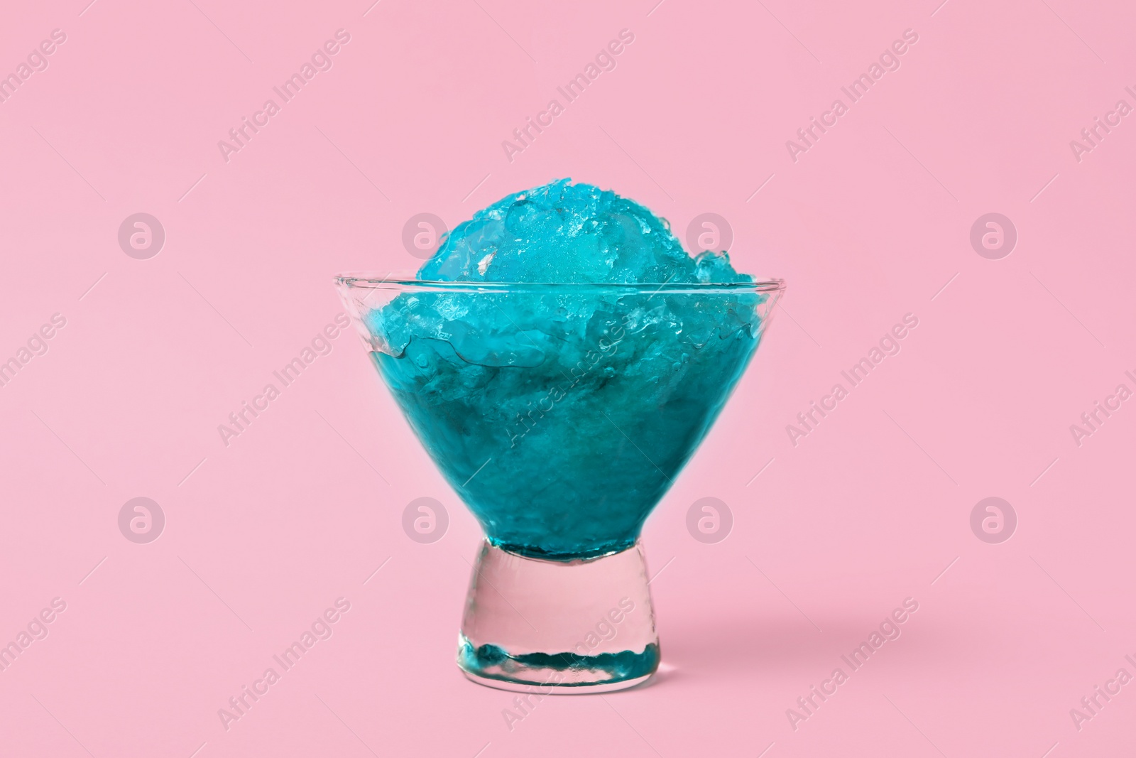 Photo of Shaving ice in glass dessert bowl on pink background, closeup