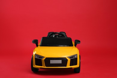 Photo of Child's electric toy car on red background