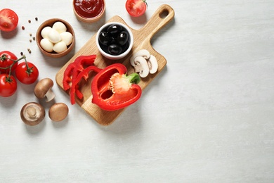 Photo of Flat lay composition with fresh pizza  ingredients on white wooden table. Space for text