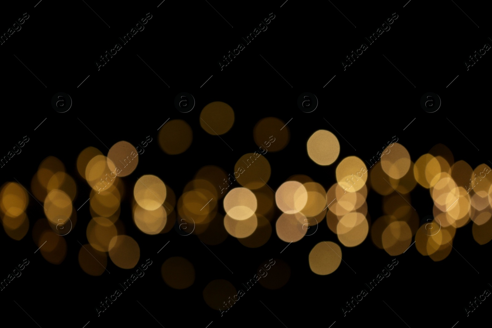 Photo of Blurred view of beautiful lights on black background. Bokeh effect