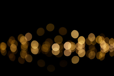 Blurred view of beautiful lights on black background. Bokeh effect