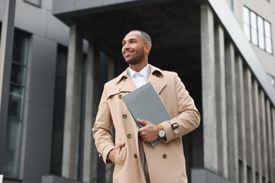 Photo of Happy man with folders outdoors. Lawyer, businessman, accountant or manager