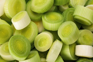 Photo of Fresh raw leek slices as background, above view
