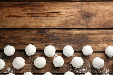 Photo of Snowballs on wooden background, flat lay. Space for text