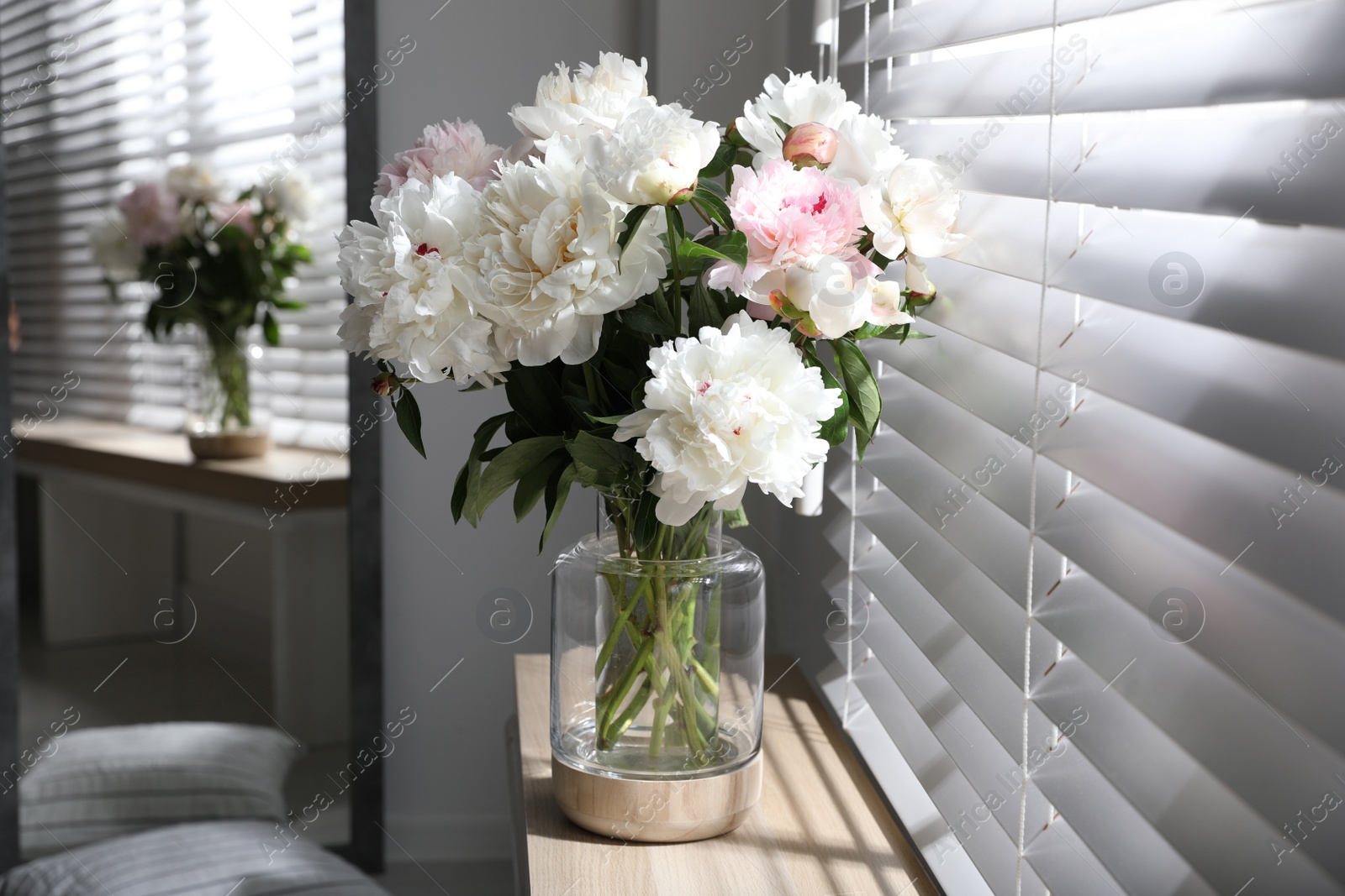 Photo of Bouquet of beautiful peony flowers on window sill indoors