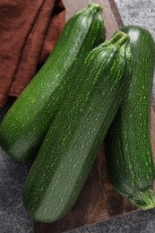 Photo of Raw ripe zucchinis on grey table, top view