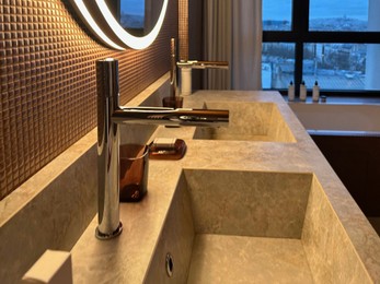 Modern sinks and faucets in hotel bathroom