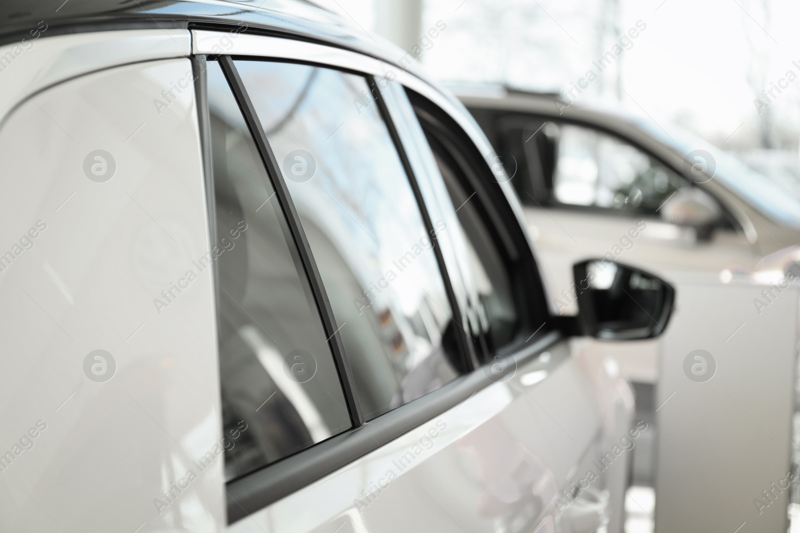 Photo of Modern car with tinting foil on window, closeup